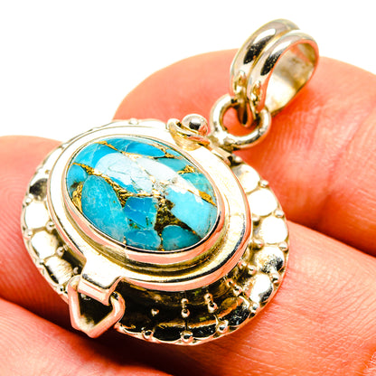 Turquoise oval pendant in gold-tone bezel with loop bail and ornate frame