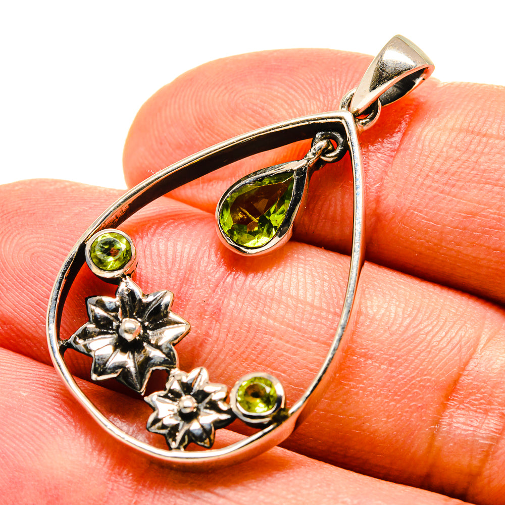 Sterling silver teardrop pendant close-up with green peridot teardrop and round stones