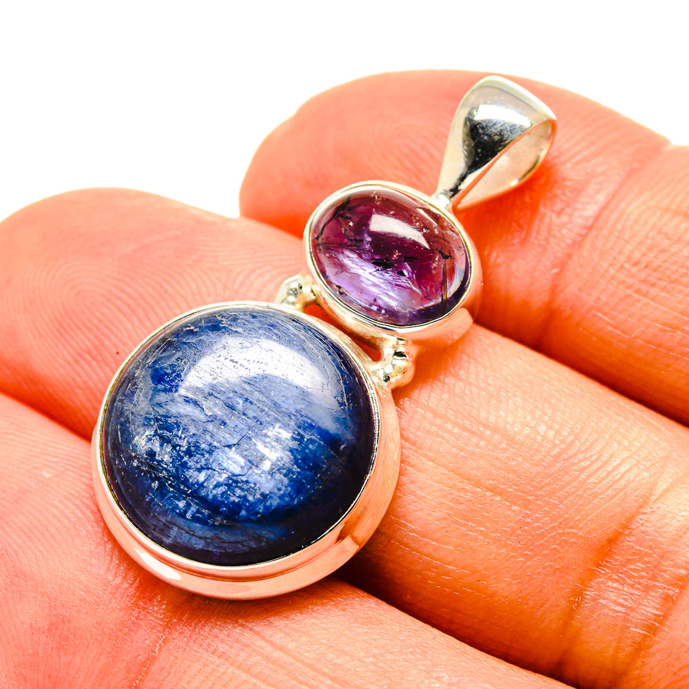 Sterling silver pendant closeup with large oval blue stone and round purple stone
