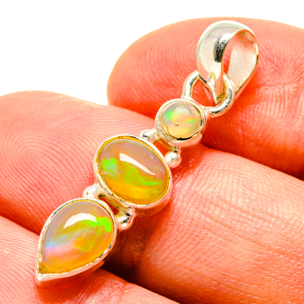 Sterling silver opal pendant close-up with three oval cabochons showing rainbow iridescence
