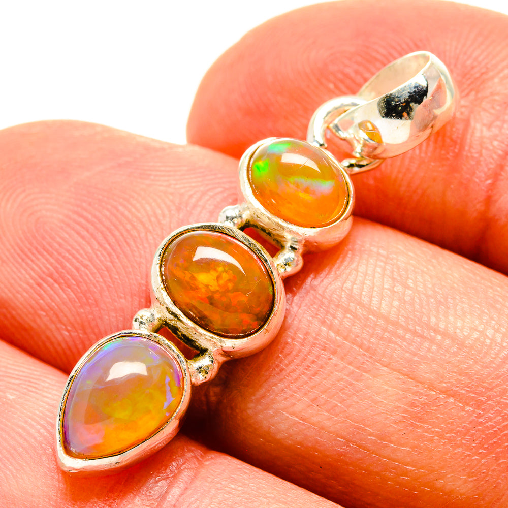 Sterling silver opal pendant close-up with four oval cabochons in orange and pale purple