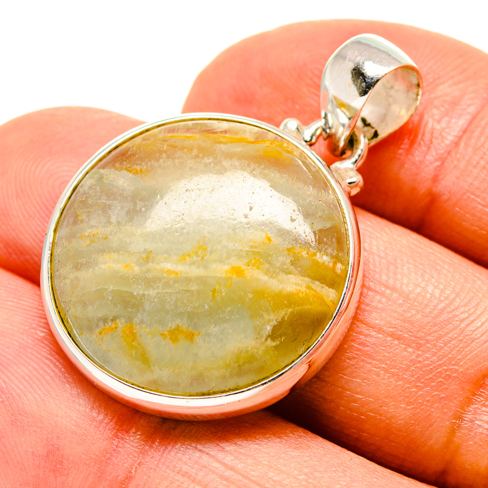 Sterling silver fluorite pendant with round green-gold cabochon on silver bail