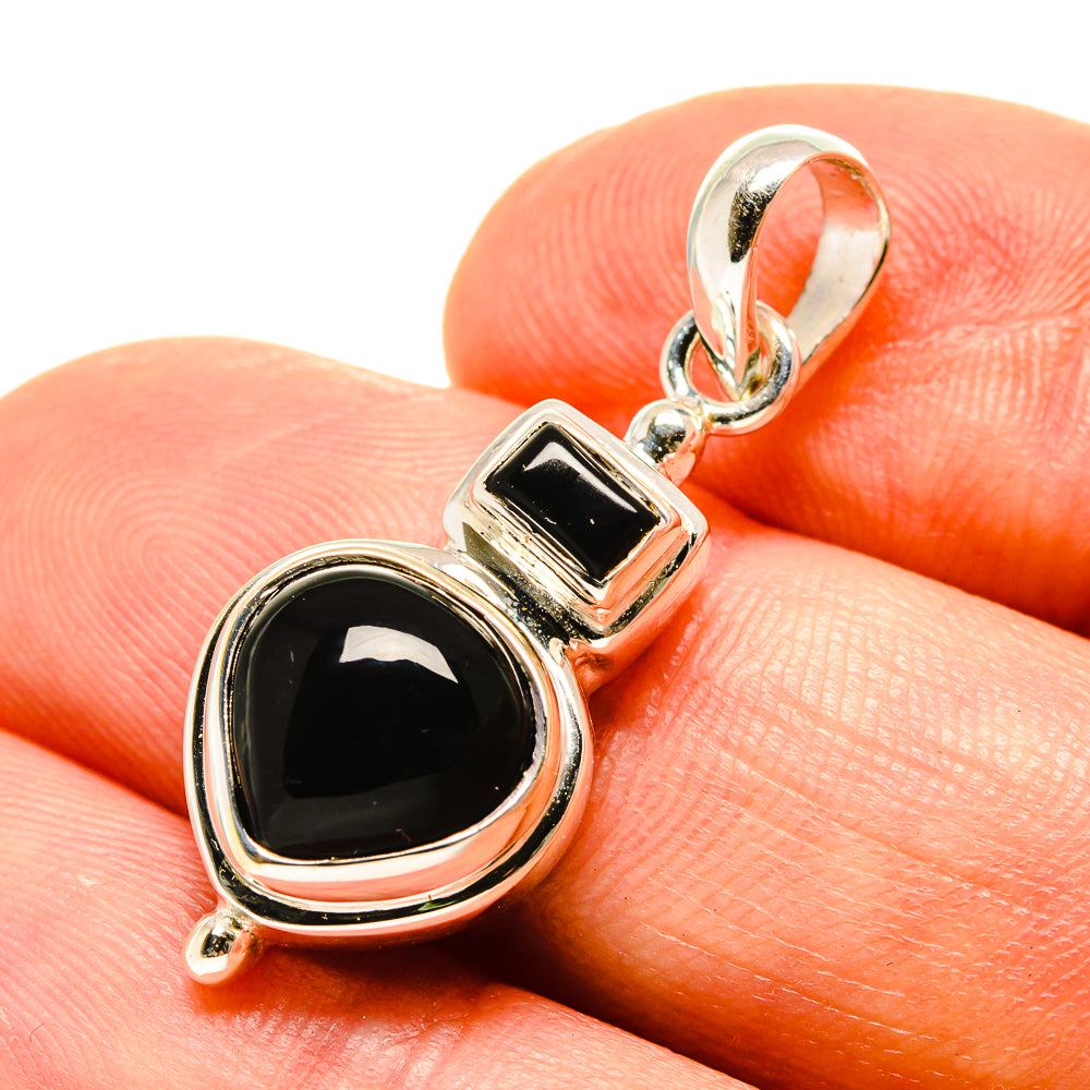 Black onyx pendant in sterling silver with round and square bezel settings, hanging loop