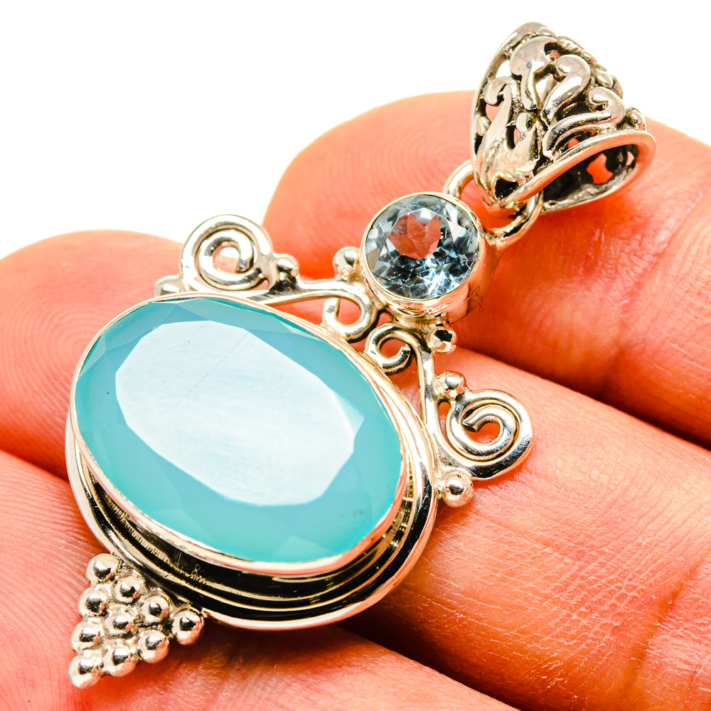 Blue chalcedony and blue topaz pendant in sterling silver with ornate scroll setting