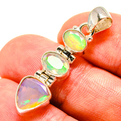 Sterling silver opal pendant with four faceted oval rainbow stones and loop bail