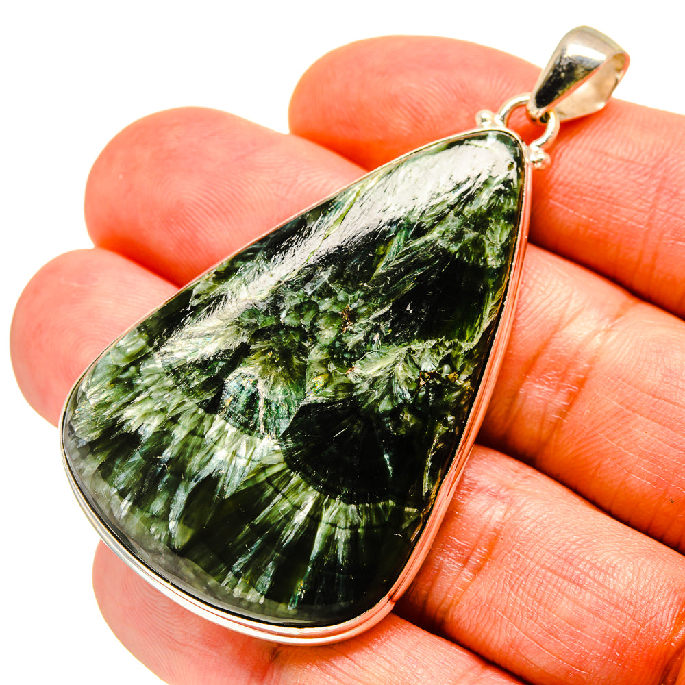 Seraphinite teardrop pendant with green stone set in sterling silver bezel