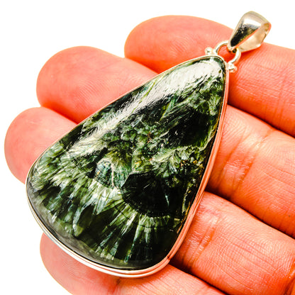 Seraphinite teardrop pendant with green stone set in sterling silver bezel
