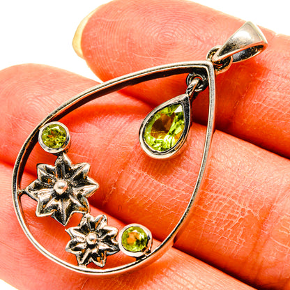 Teardrop pendant with green peridot stones, star accents, and loop bail