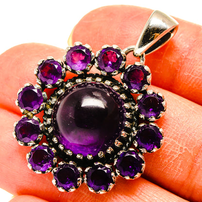 Amethyst pendant in silver with purple round stones and a large oval center stone