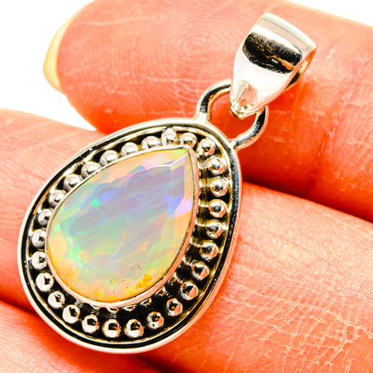 Faceted opal teardrop pendant with gold-tone beaded halo bezel