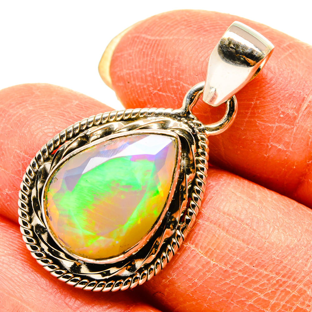 Sterling silver opal pendant with oval faceted Ethiopian opal and ornate bezel