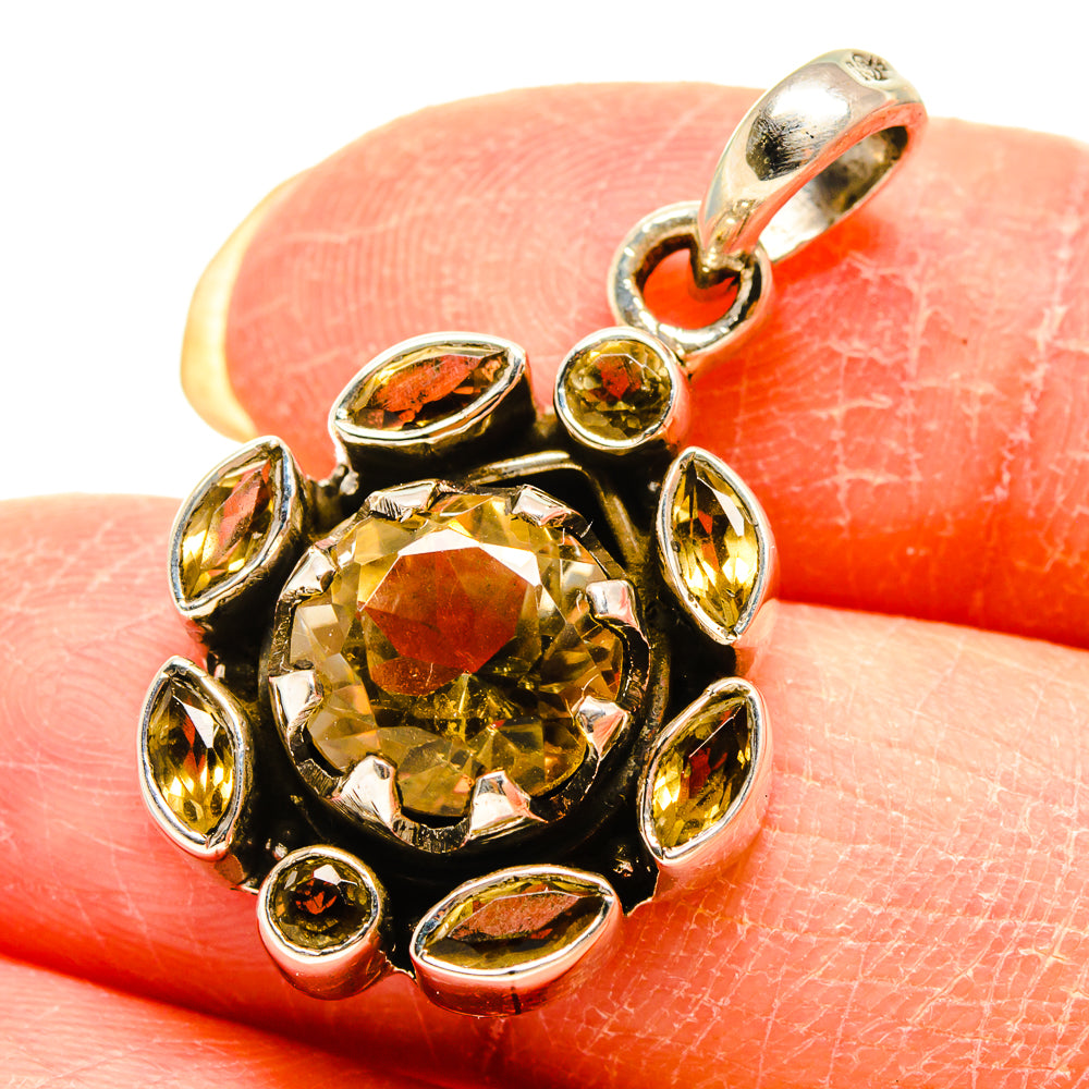 Citrine pendant closeup with silver-tone bail and oval accent stones around center