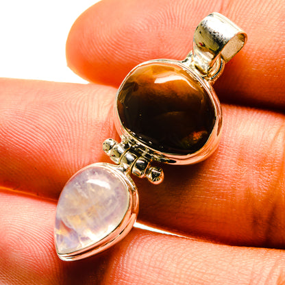 Sterling silver pendant close-up with brown fire agate and opalescent moonstone drop