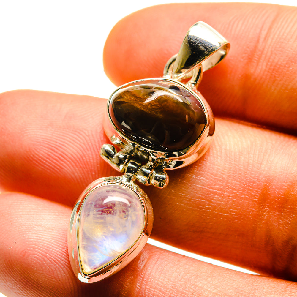 Sterling silver gemstone pendant close-up with amber teardrop and rainbow moonstone