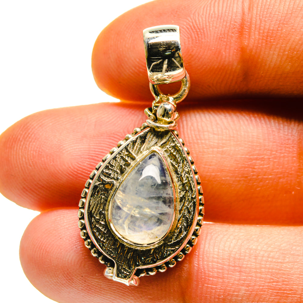 Rainbow moonstone poison pendant close-up, teardrop cabochon in gold-tone 925 silver