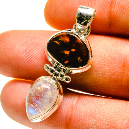 Sterling silver pendant with dark amber oval cabochon and iridescent moonstone drop