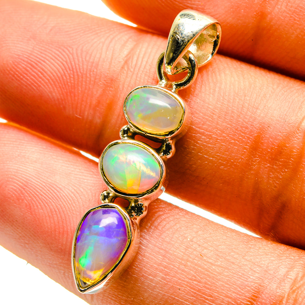 Opal pendant with four oval opal gemstones—green, rainbow, and purple—in 925 silver