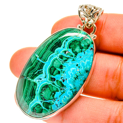 Oval malachite-chrysocolla pendant in silver with ornate bail, green and turquoise