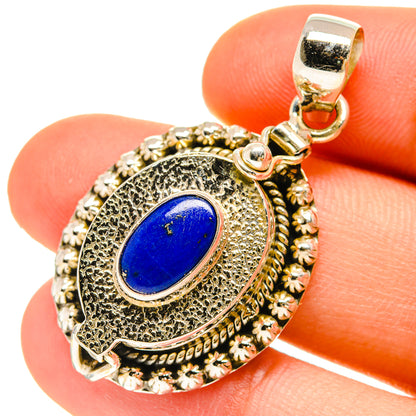 Lapis lazuli poison pendant in 925 sterling silver with oval blue stone, ornate bezel.