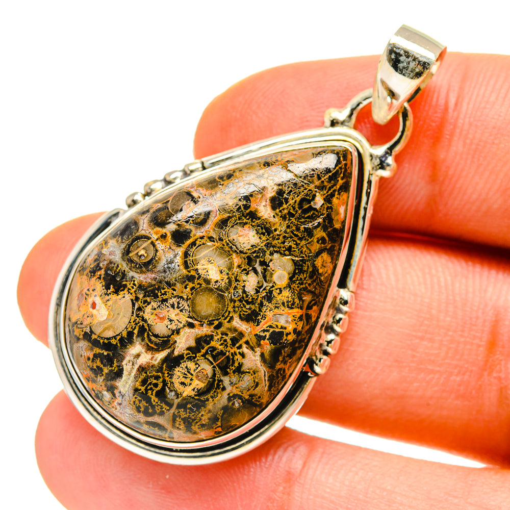 Teardrop jasper pendant with 925 sterling silver bail and border, mottled black, gold, and green.