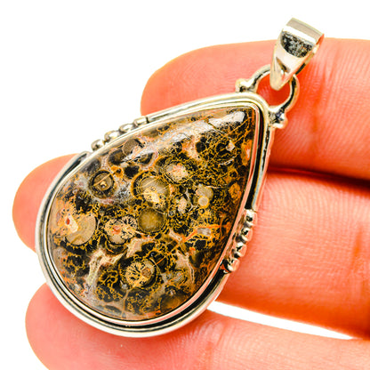 Teardrop jasper pendant with 925 sterling silver bail and border, mottled black, gold, and green.