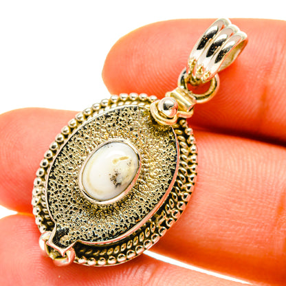 Close-up oval 925 sterling silver pendant with white cabochon and round bead edging