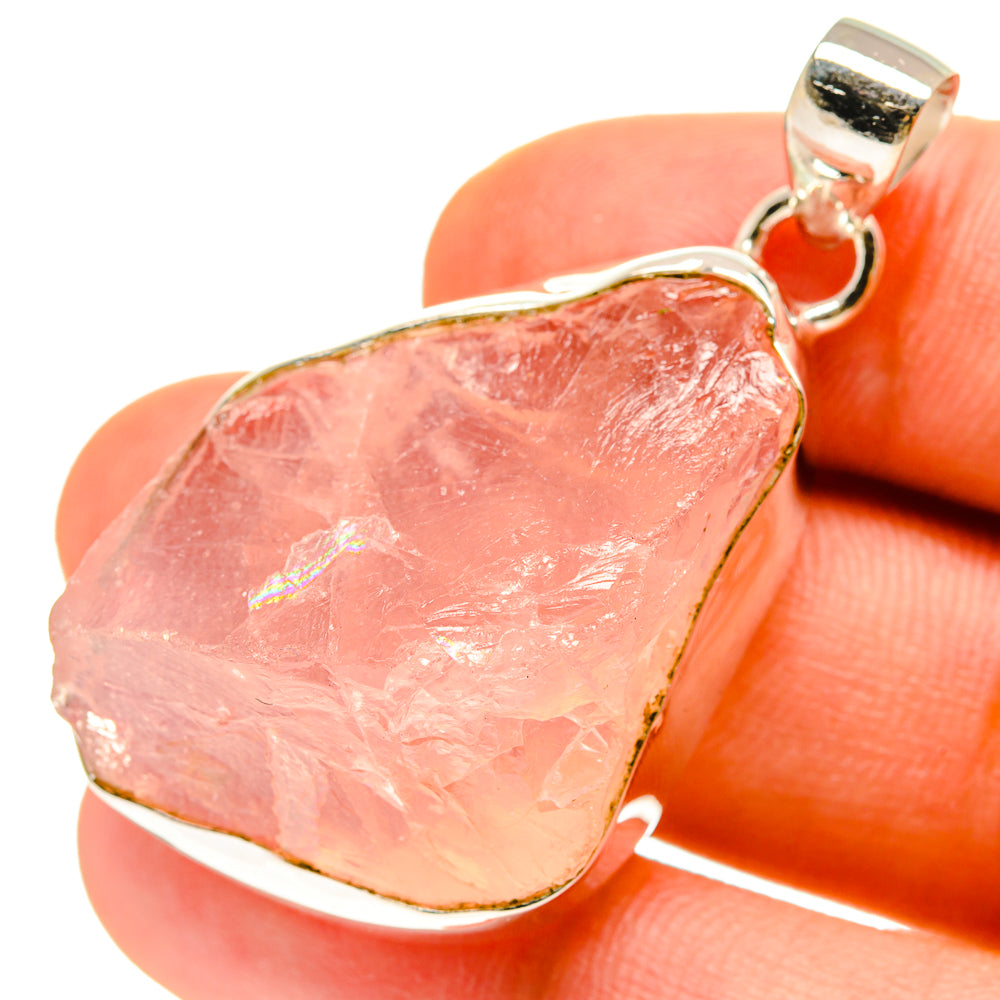 Rough rose quartz pendant with 925 sterling silver bail, close-up teardrop pink stone