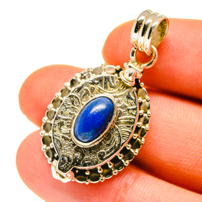 Lapis lazuli poison pendant close-up with ornate bezel and oval blue cabochon