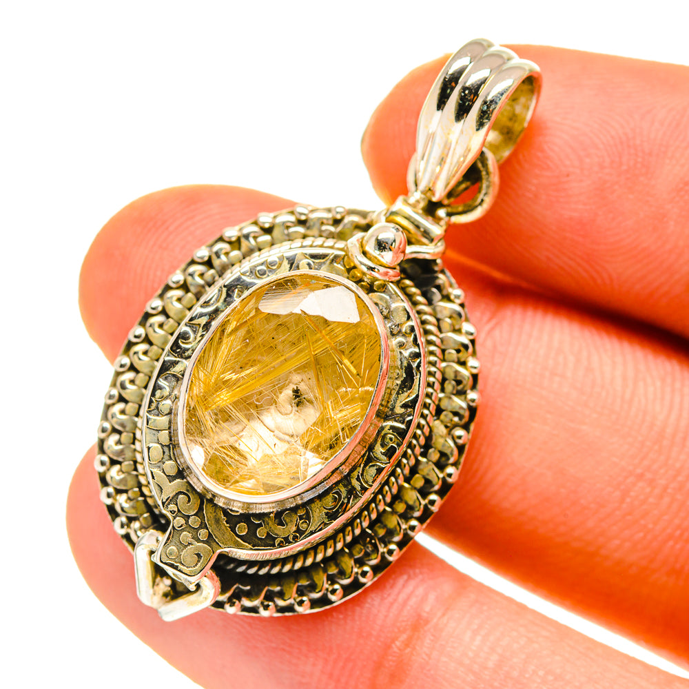 Rutilated quartz poison pendant in oval golden stone bezel with ornate silver frame