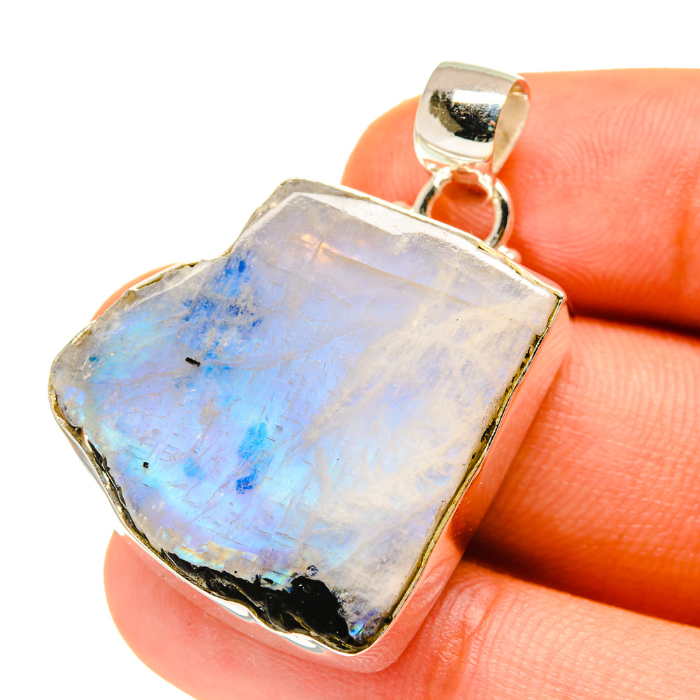 Sterling silver moonstone pendant close-up with rough iridescent rectangular stone and bezel