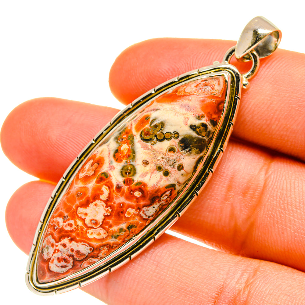 Oval ocean jasper pendant with orange-and-cream stone, black speckles, sterling silver bail