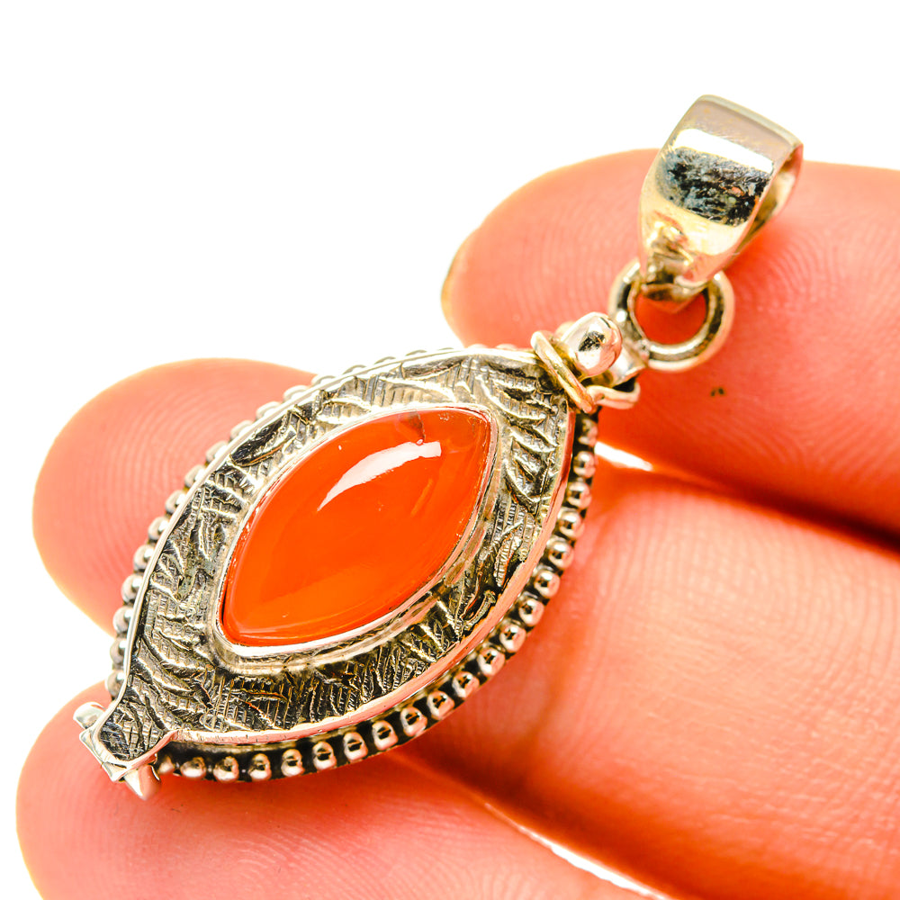Oval carnelian stone pendant in 925 sterling silver with loop bail and detailed rim