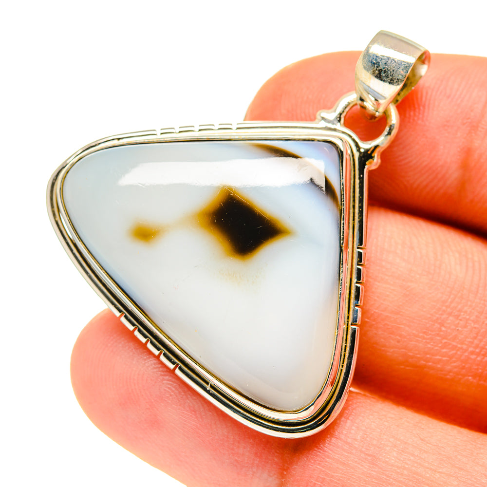 Triangular agate pendant with white, dark and tan stone in silver bezel