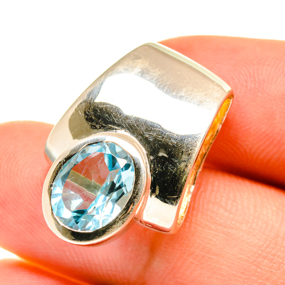 Sterling silver pendant close-up with round blue topaz center bezel and frame