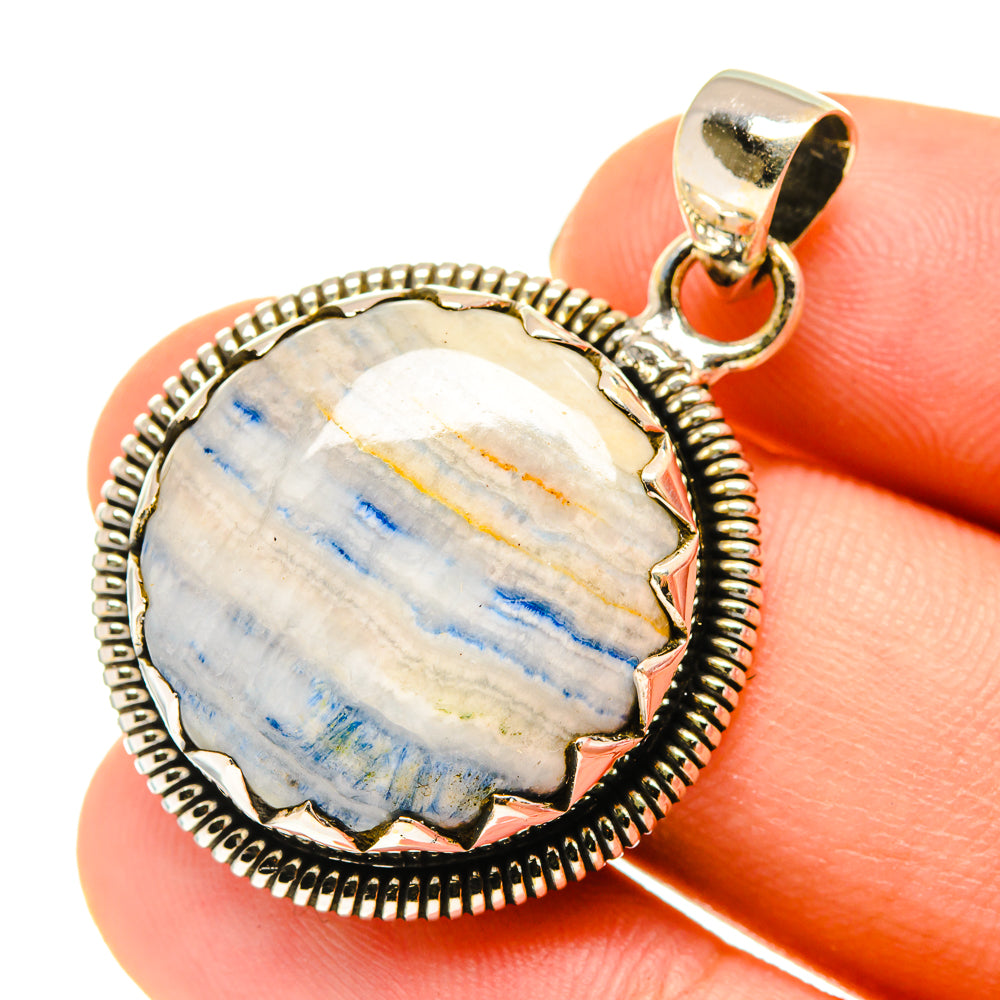 Round blue scheelite pendant with textured sterling silver border and loop bail