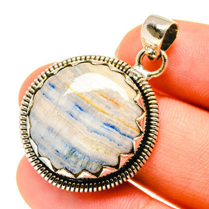 Round blue scheelite pendant with textured sterling silver border and loop bail