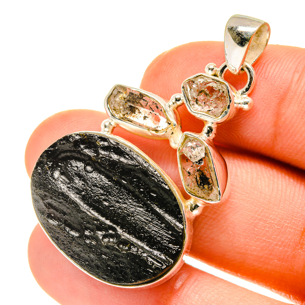 Tektite Herkimer diamond pendant close view: oval dark stone with surrounding clear crystal settings