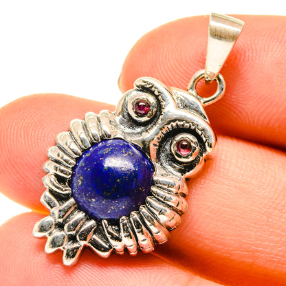 Sterling silver owl pendant with blue lapis cabochon and red garnet accents