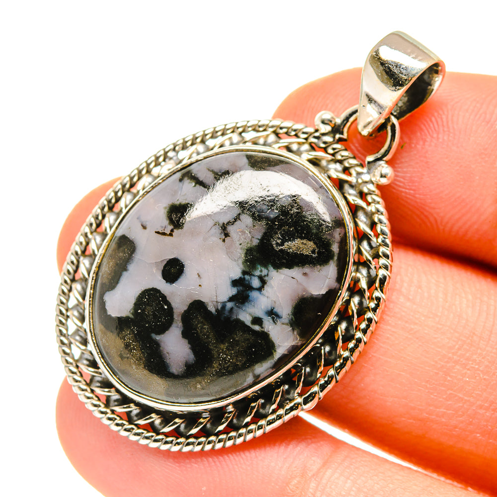 Oval sterling silver gabbro stone pendant close-up, black-and-white speckled stone, top bail