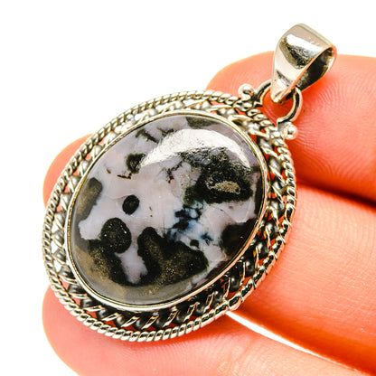 Oval sterling silver gabbro stone pendant close-up, black-and-white speckled stone, top bail