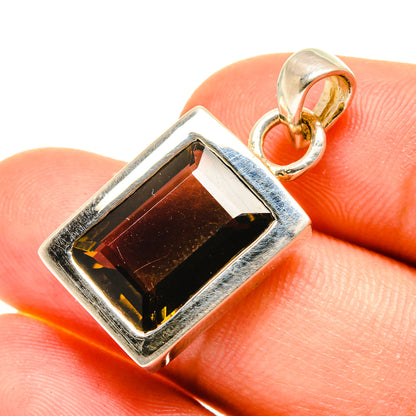 Smoky quartz pendant close-up: rectangular dark stone in silver bezel with bail