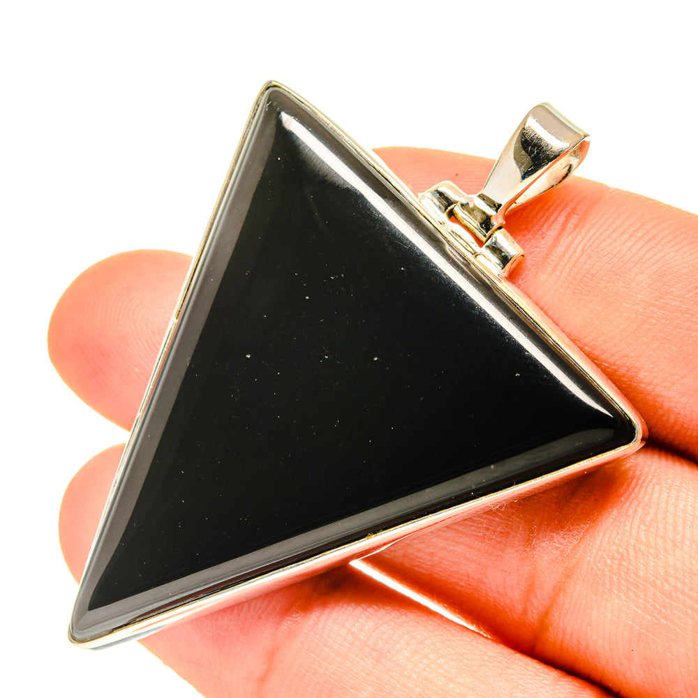 Black onyx pendant in 925 sterling silver, triangular stone with bail on hand