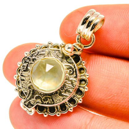 Sterling silver prehnite pendant showing round halo bezel and green oval cabochon