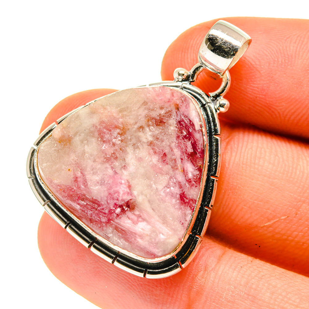 Heart-shaped pink tourmaline-in-quartz pendant in sterling silver frame.
