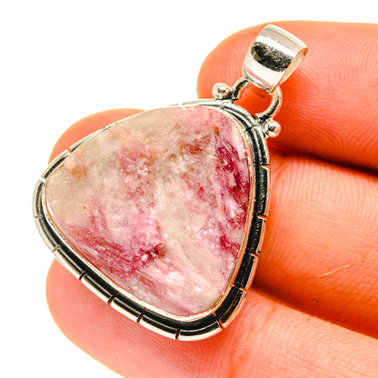 Heart-shaped pink tourmaline-in-quartz pendant in sterling silver frame.