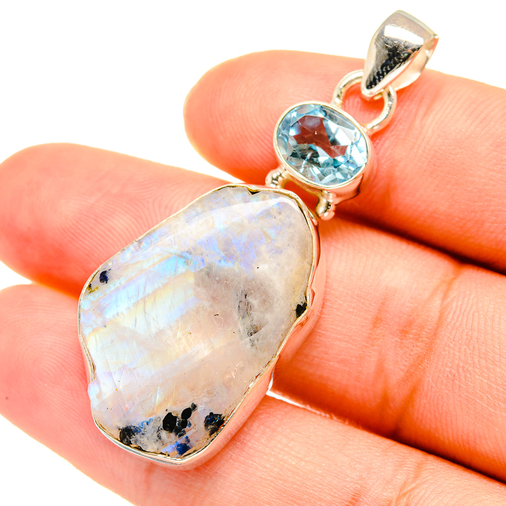 Sterling silver pendant with teardrop moonstone and round light-blue topaz, close-up