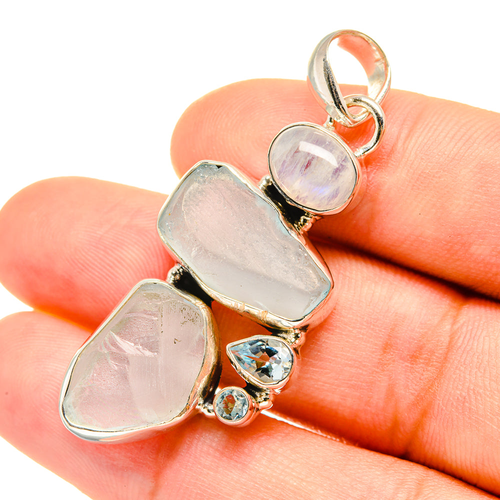 Sterling silver gemstone pendant close-up: rough pale-blue stones with round accents