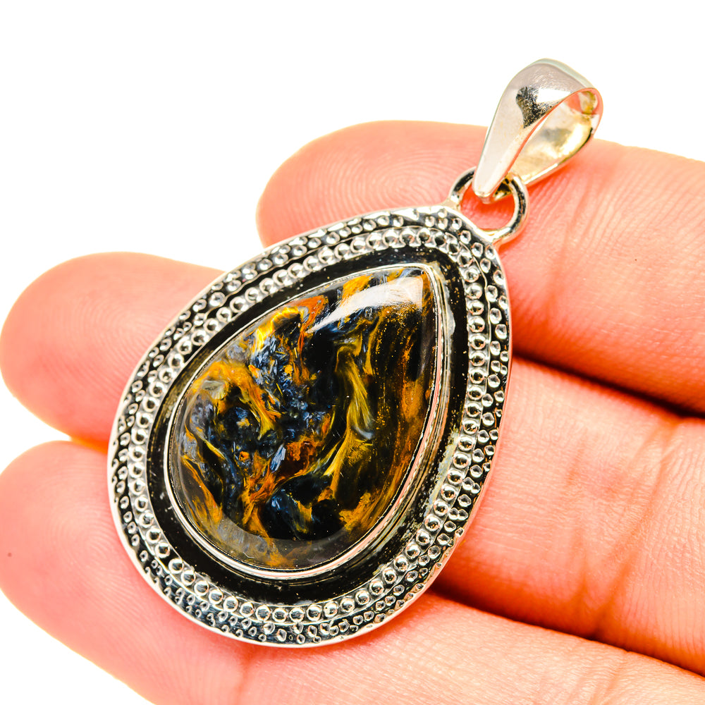 Pietersite teardrop pendant with gold-toned top bail, textured silver frame, oval stone