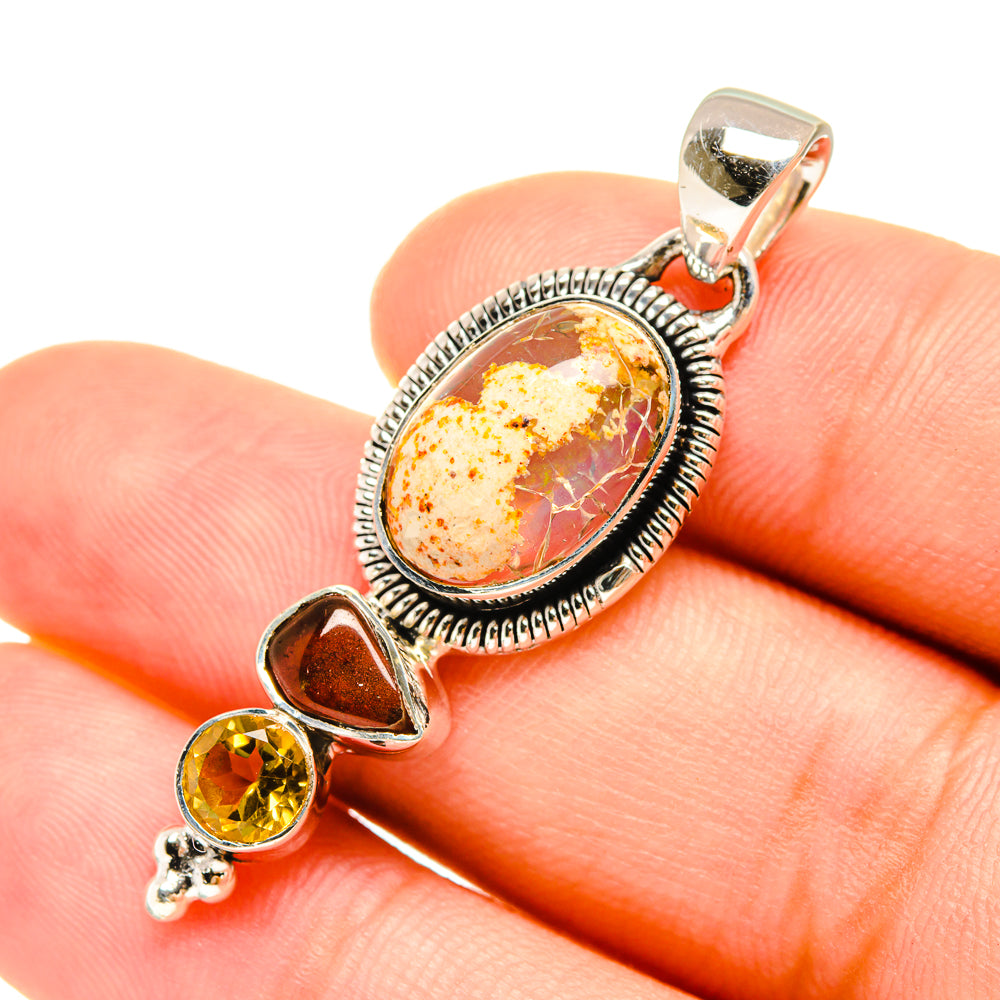 Sterling silver pendant featuring oval fire opal cabochon and citrine teardrop accents