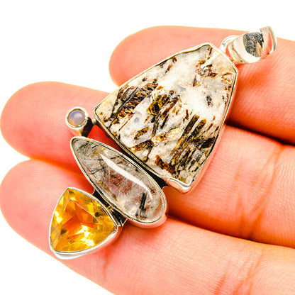 Sterling silver gemstone pendant with rough white stone, yellow teardrop, and round white accent.